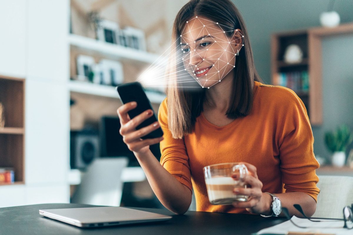 Facial recognition software, on a phone, scanning a woman's face.